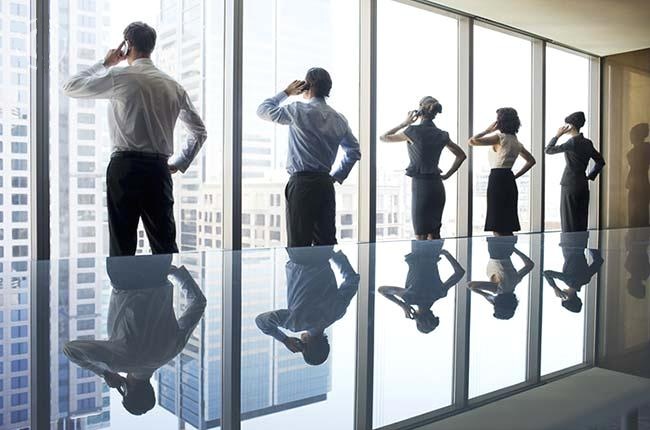 Business people using cell phones in conference room